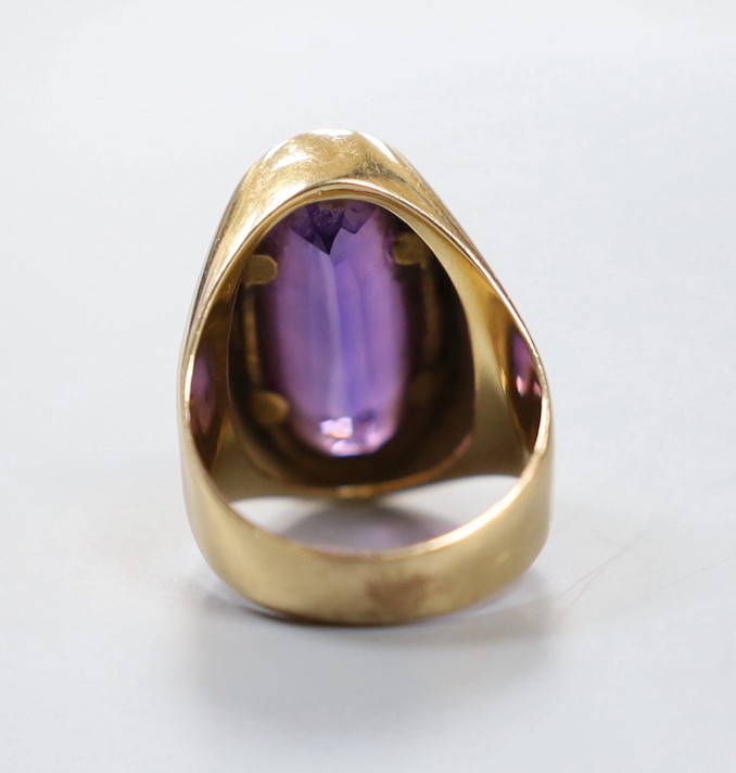 A Middle Eastern 750 yellow metal and synthetic colour change corundum set dress ring, size O, gross weight 11.8 grams.